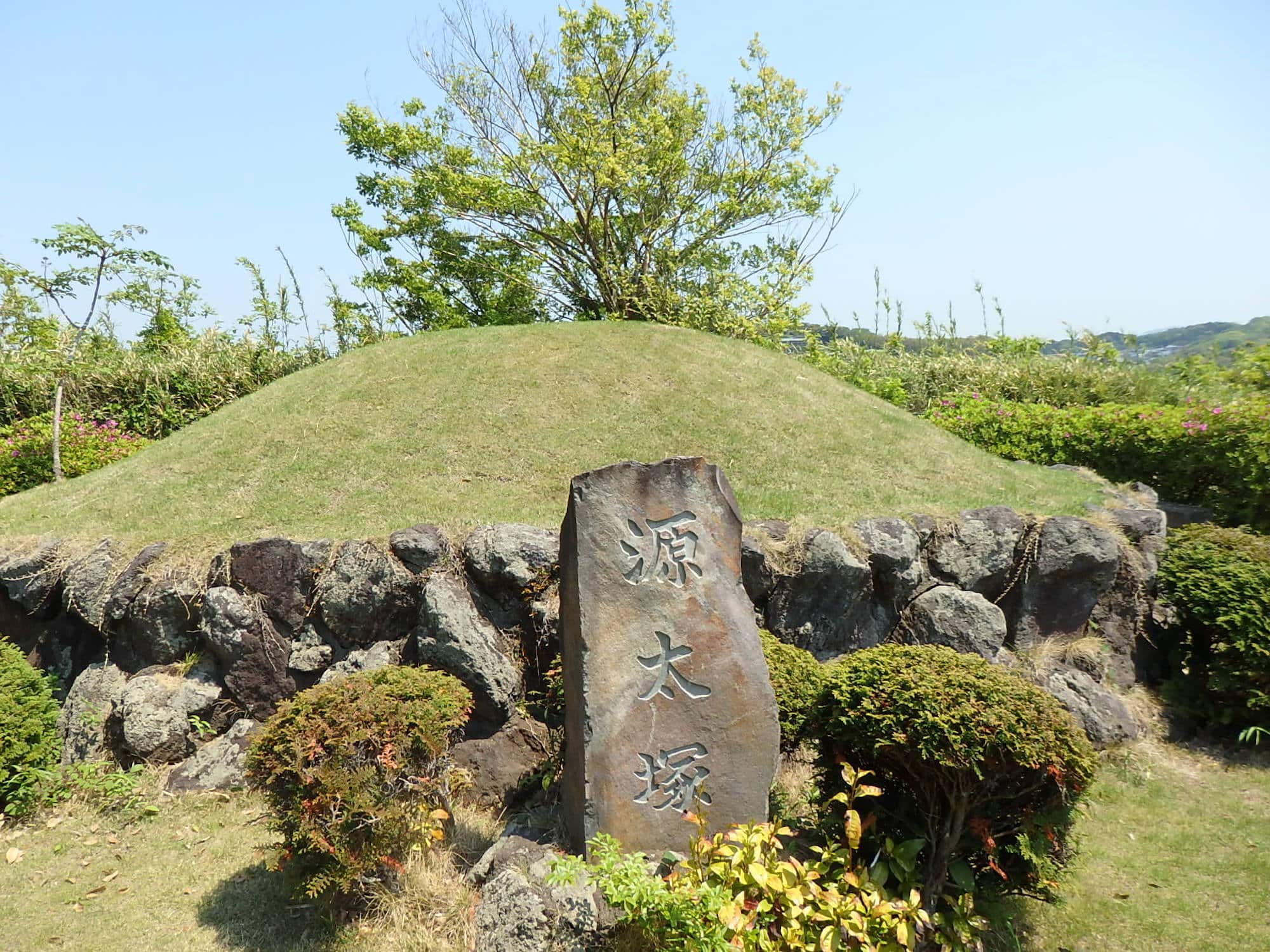 ツツジ咲く山道を登った頂上にある源太塚。鎌倉時代の武将・梶原源太景季をまつる