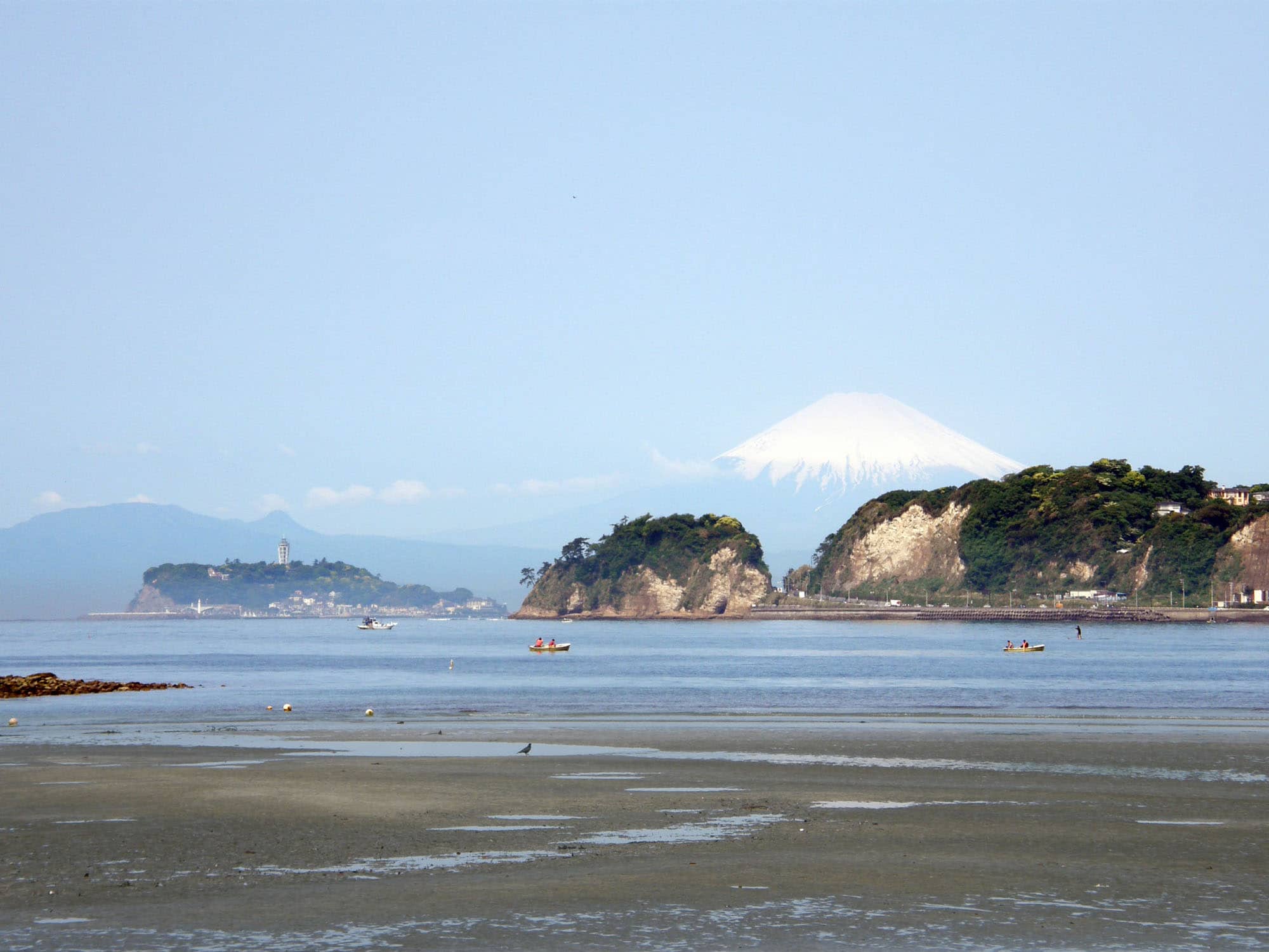 和賀江嶋より由比ヶ浜方面を望む。富士山と江ノ島、稲村ヶ崎が見える。写真左が和賀江嶋の岩場。名だたる観光地・由比ヶ浜海水浴場の近くにある和賀江嶋は、人が大勢訪れることで自然環境への影響も心配されている
